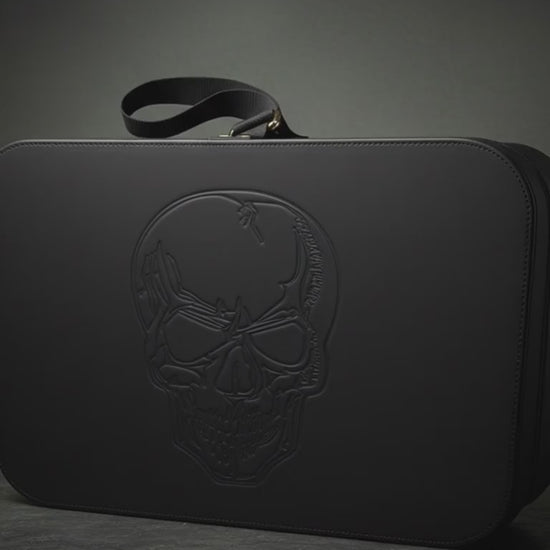zoom in video on carry-on travel case with skull embossed in faux black leather for travel or storage
