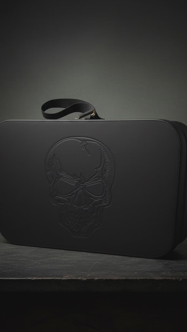 zoom in video on carry-on travel case with skull embossed in faux black leather for travel or storage